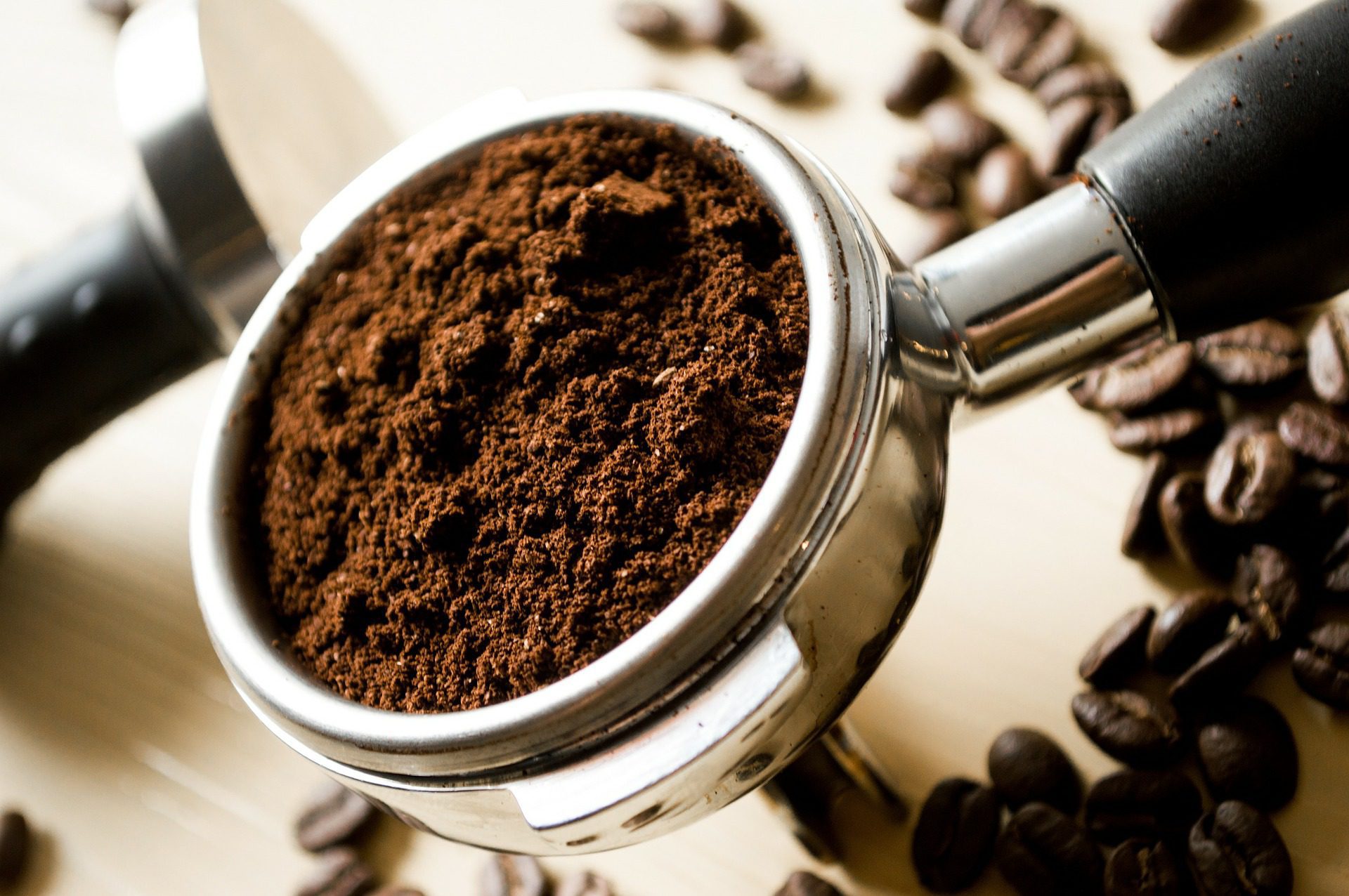 Ground coffee in an expresso shot handle. chocolate carnival citrus caramel